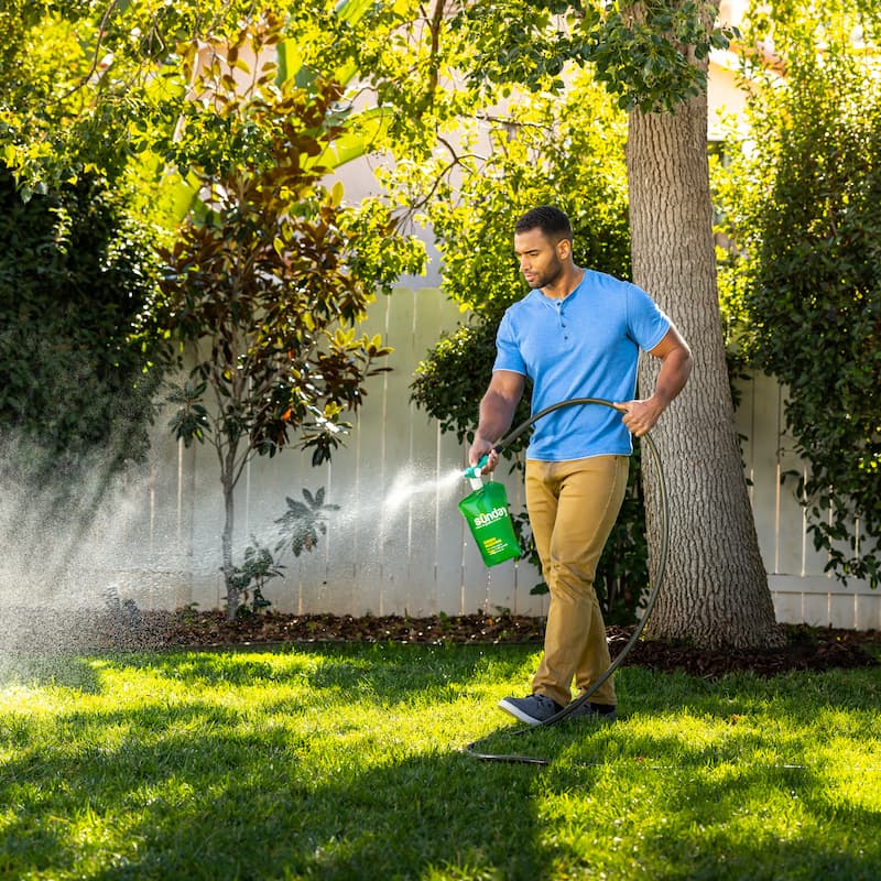 man applying sunday's non toxic eco friendly lawn products